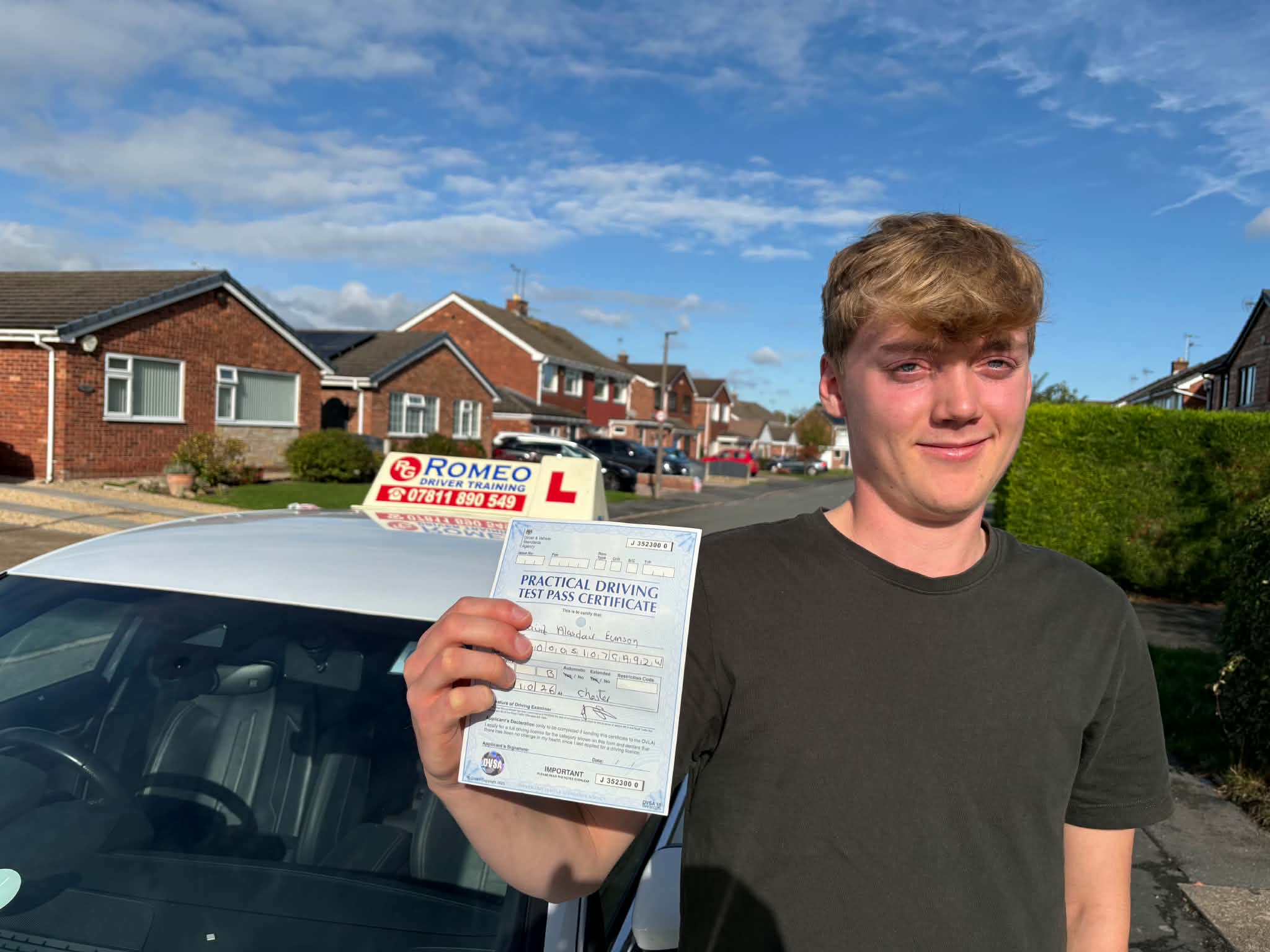 Geraint Eunson holding his pass certificate after passing his driving test in Chester