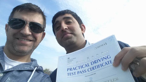 Giuseppe Romeo celebrating with a learner who has just passed his practical driving test